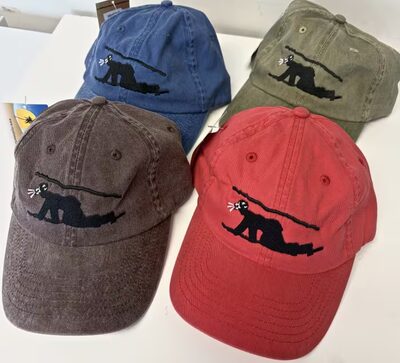 Four embroidered bat baseball caps in blue, olive, brown and red
